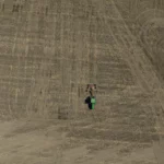 John Deer tractor on the big field covered with soil. Photo taken by drone from the air from high altitude.